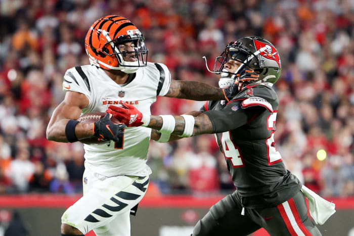 Dec 18, 2022; Tampa, Florida, USA; Cincinnati Bengals wide receiver Ja'Marr Chase (1) holds off Tampa Bay Buccaneers cornerback Carlton Davis III (24) in the third quarter at Raymond James Stadium. Mandatory Credit: Nathan Ray Seebeck-USA TODAY Sports